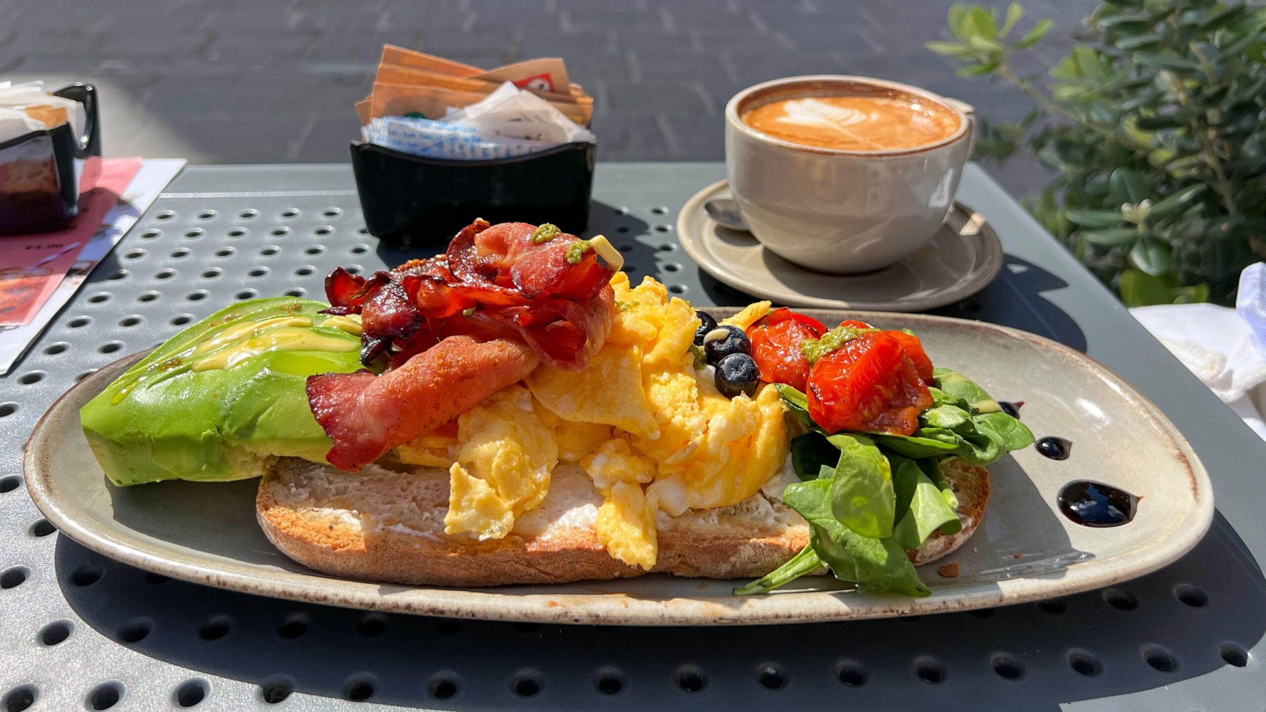 Scrambled eggs on toast with bacon.