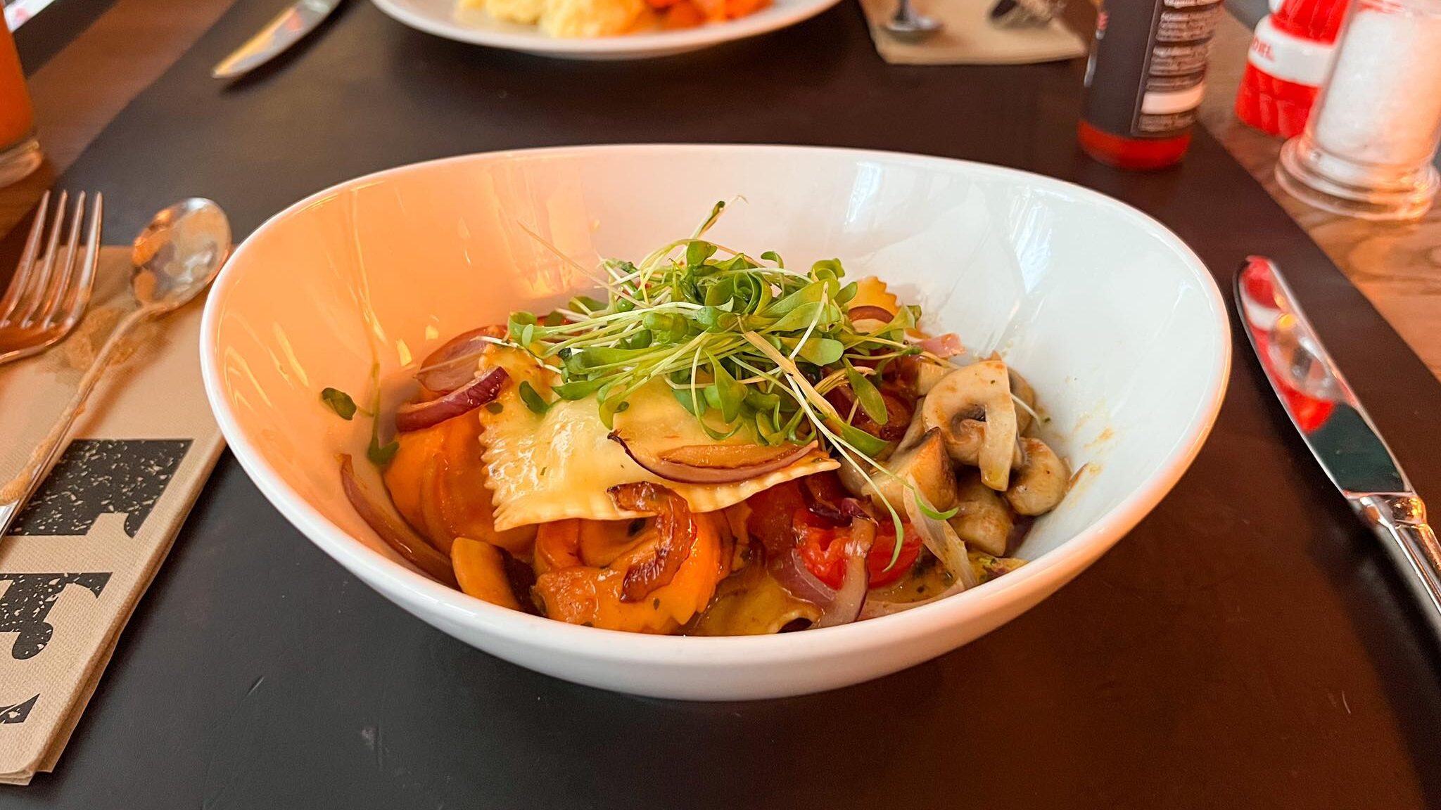 Bowl filled with seasonal ravioli in restaurant.