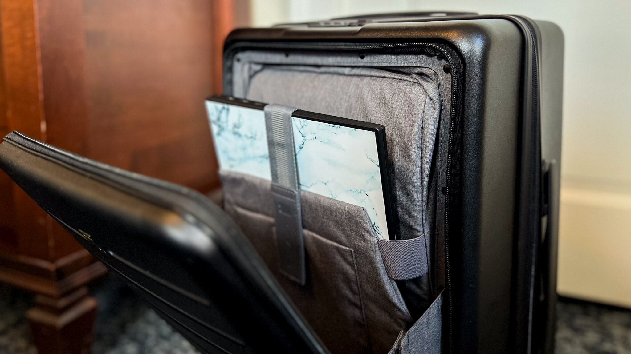 Laptop compartment on the front of a suitcase. 