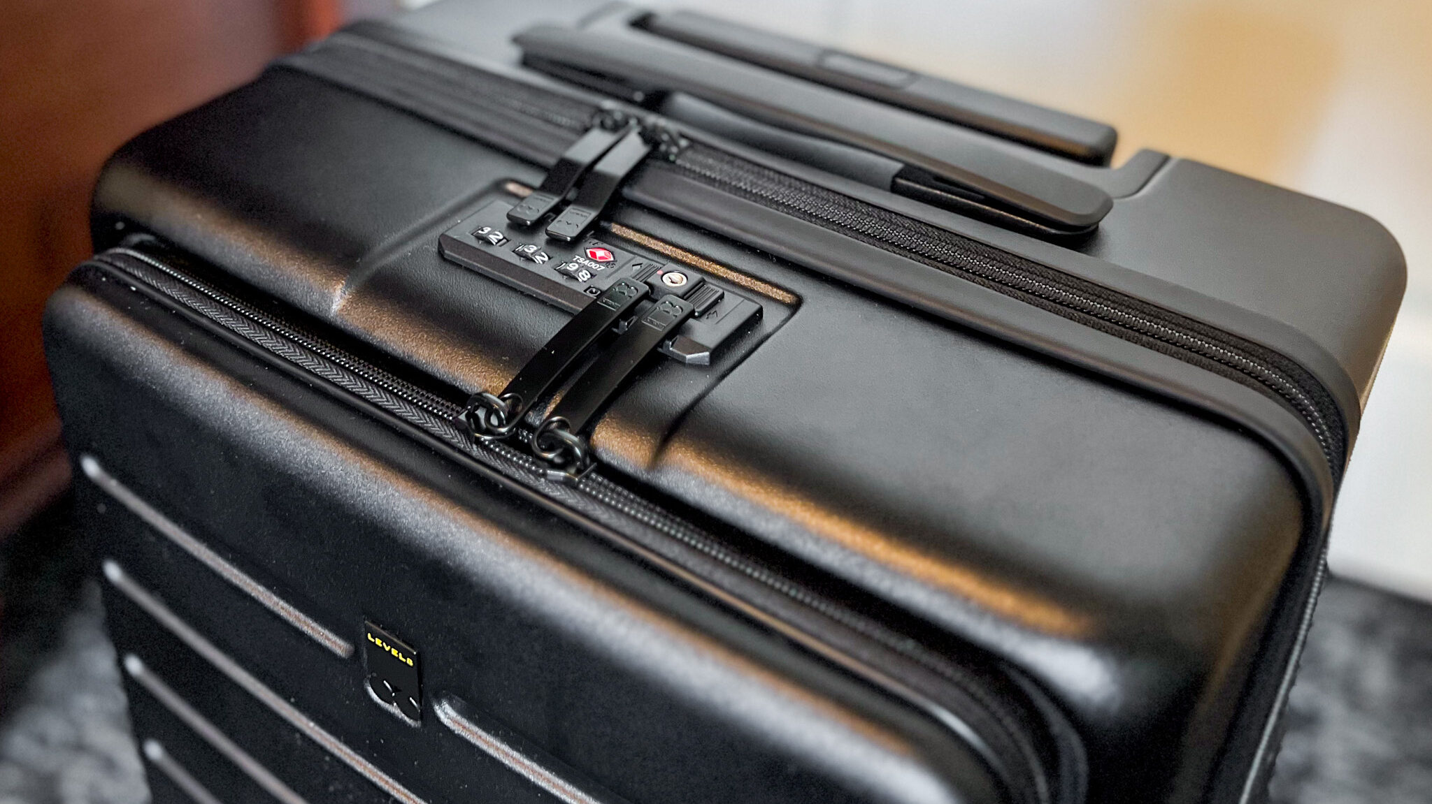 Secure lock system on the top of a suitcase. 