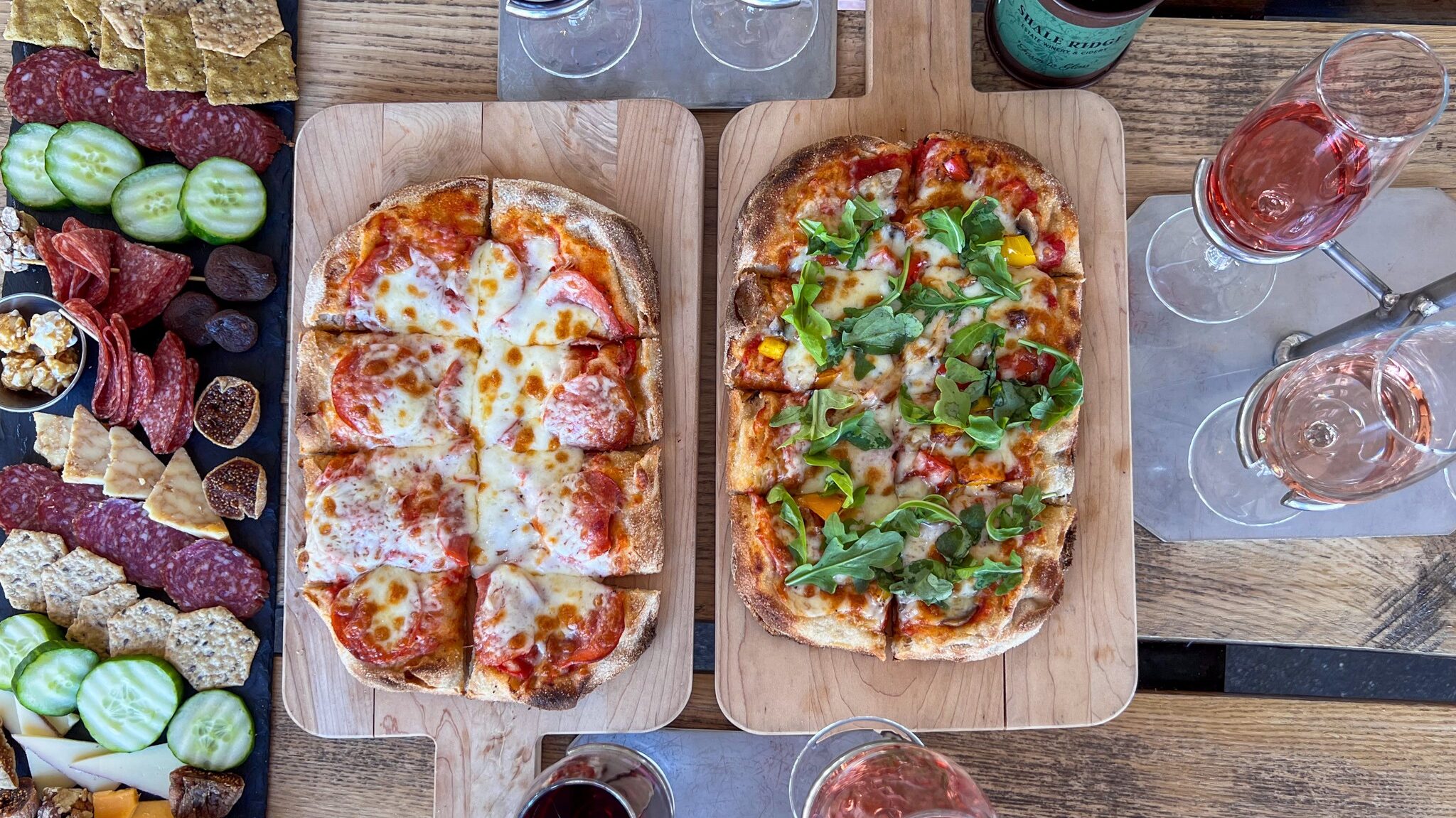 Selection of wine and pinsas at winery. 