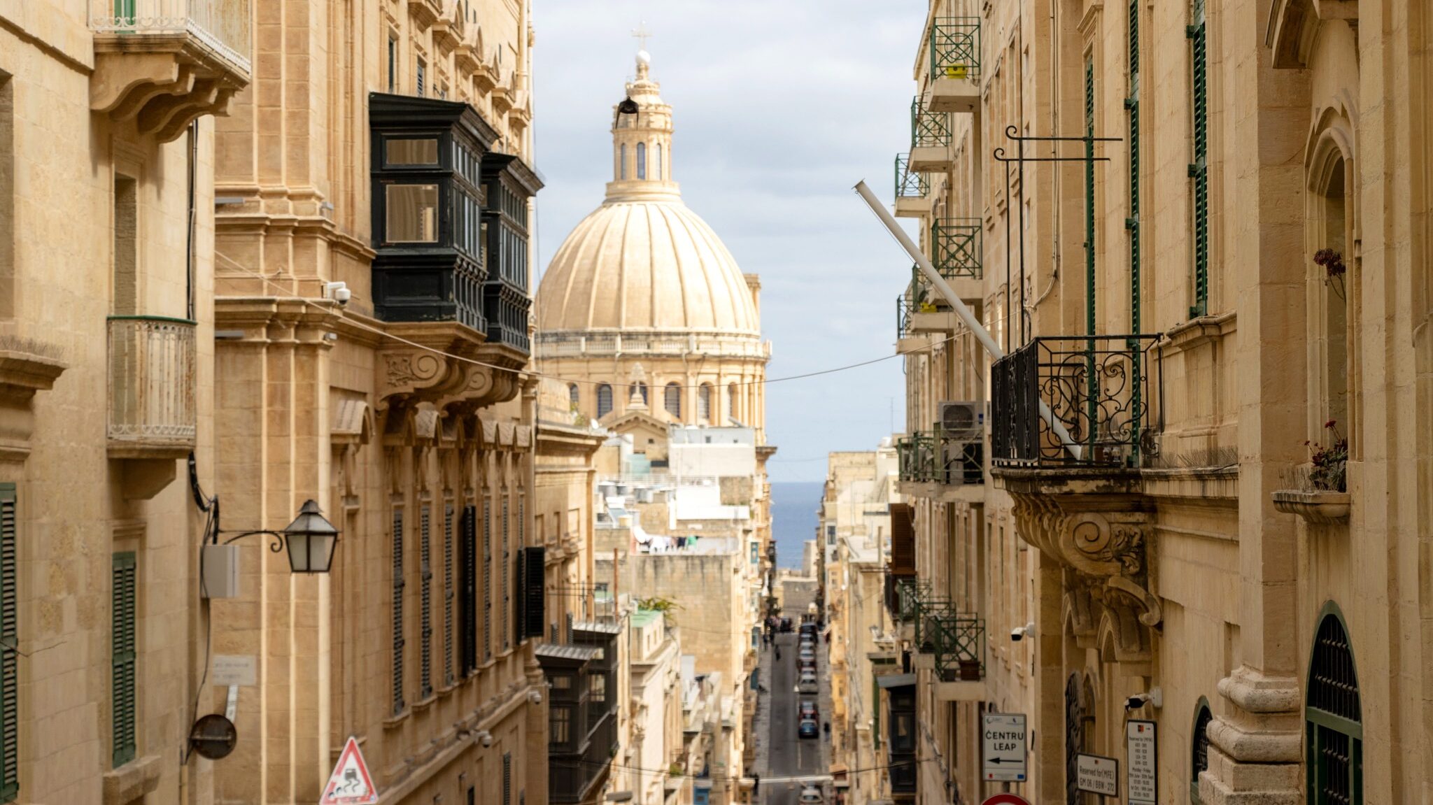 Dome of cathedral at the end of street.