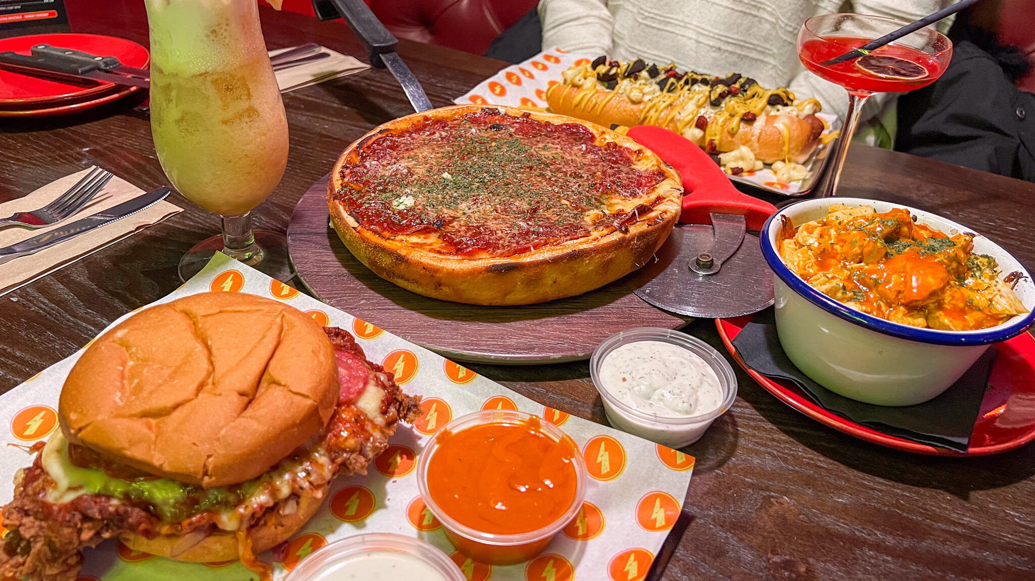 Deep dish pizza with chicken burger and macaroni. 