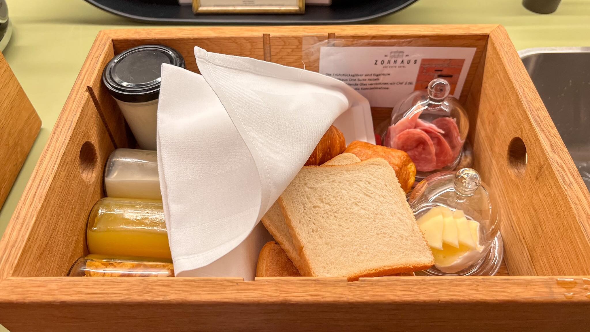 Wooden box with breakfast items inside.