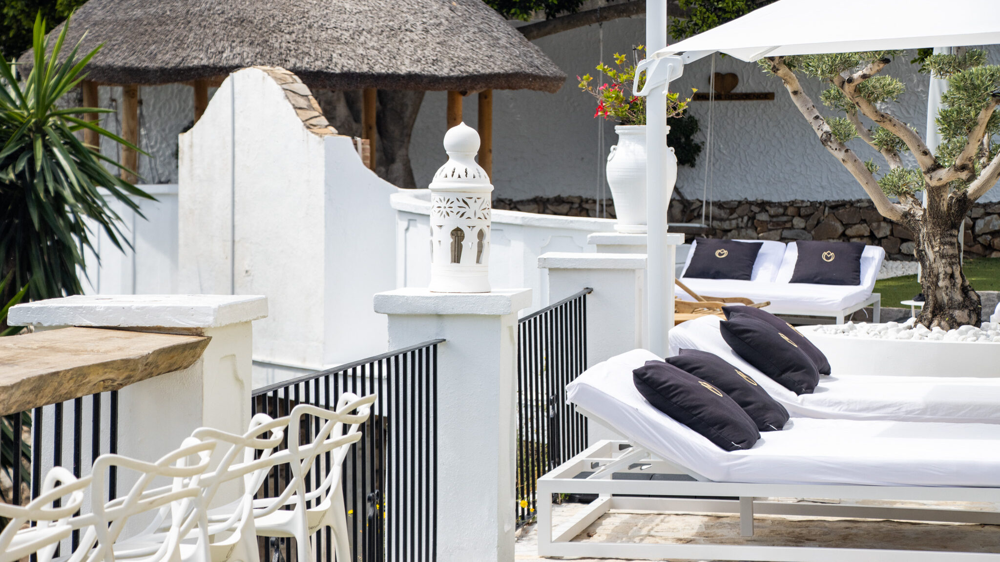 Sun terrace at villa with lounge chairs.