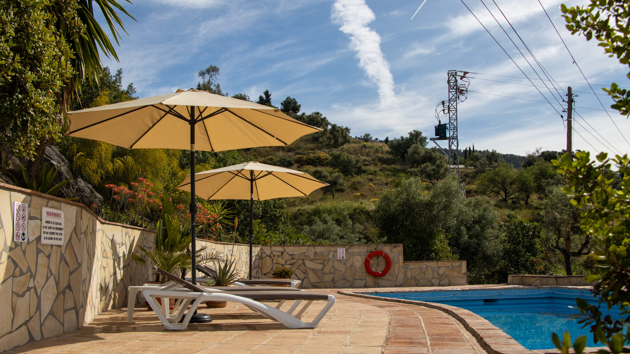 Large pool at B&B with lounge chairs.