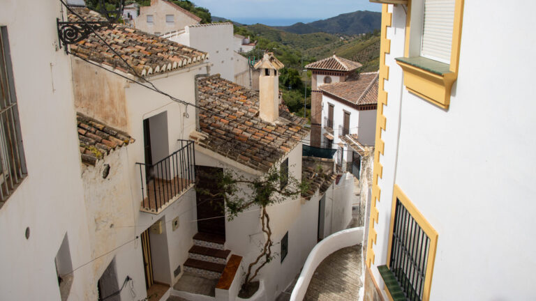 Narrow street in Sedella with steps.