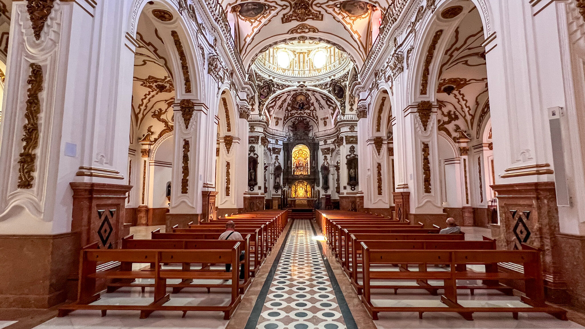 Interior of church in Malaga with white walls.