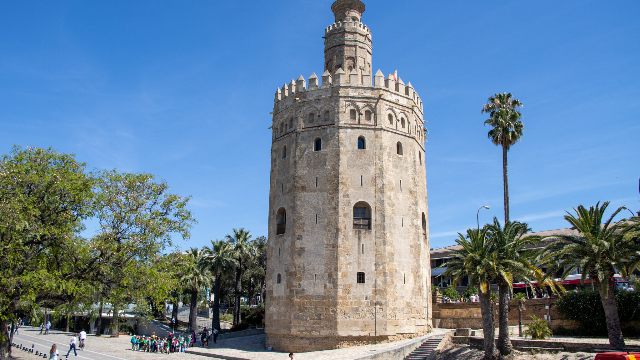 Iconic hexagonal tower in Sevilla next to river.