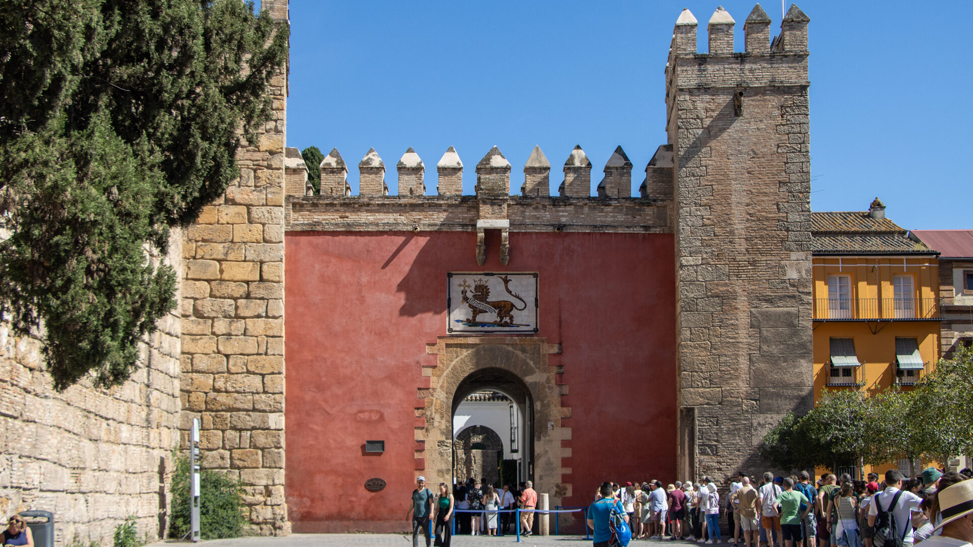 Entry gate to palace in Seville painted red.