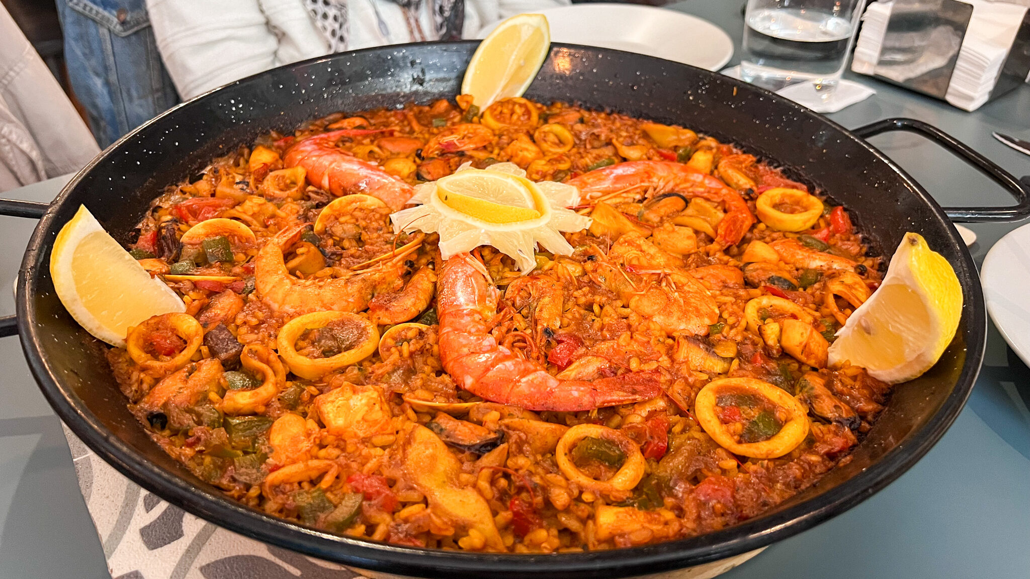 Large pan of mixed paella on table.