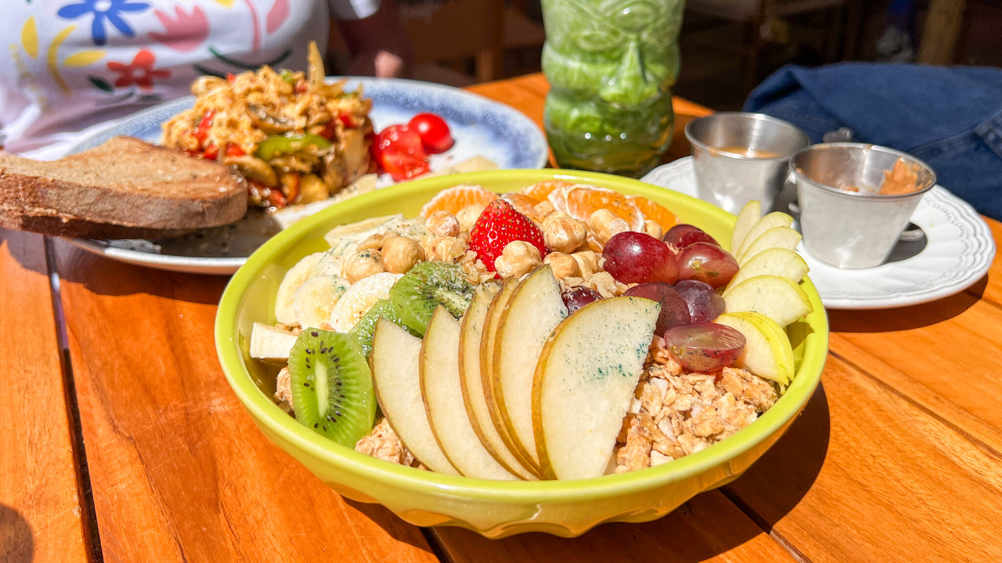 Fruit and granola bowl with green smoothie.