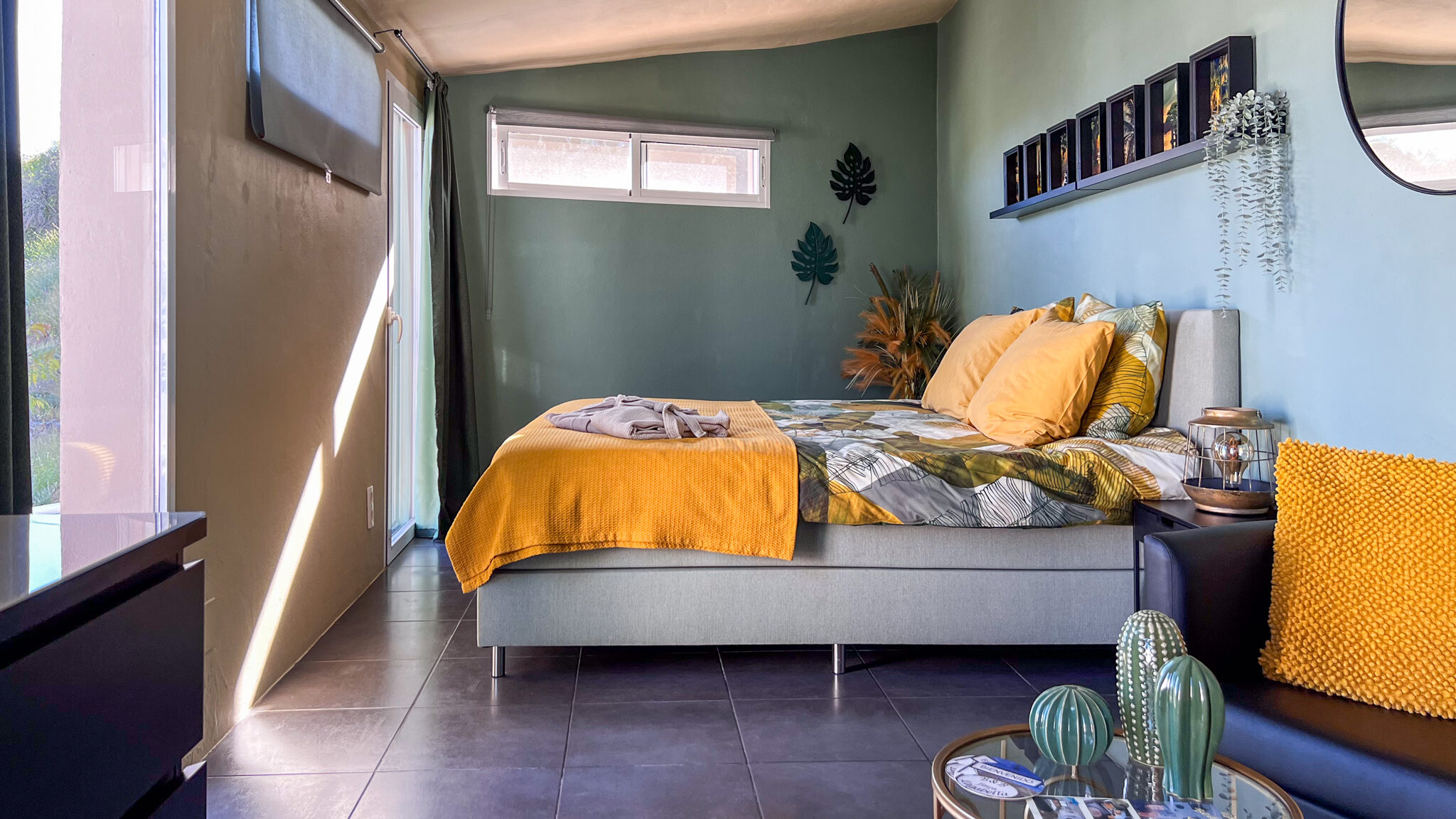 Room painted green with yellow pillows.