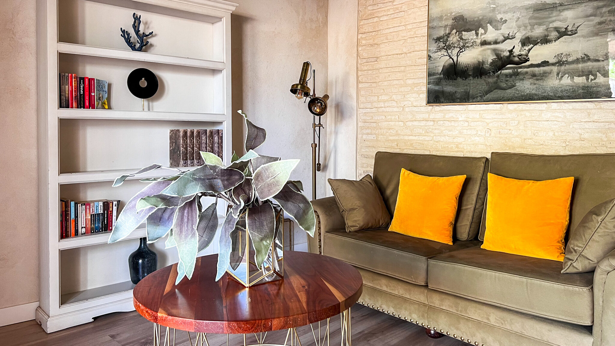 Seating area with bookshelf in suite.