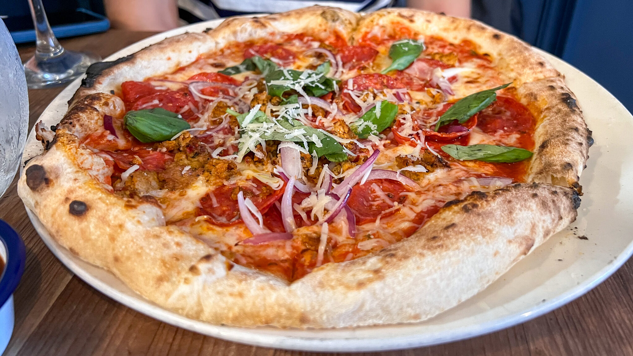 Stone baked pizza with pepperoni and peppers.