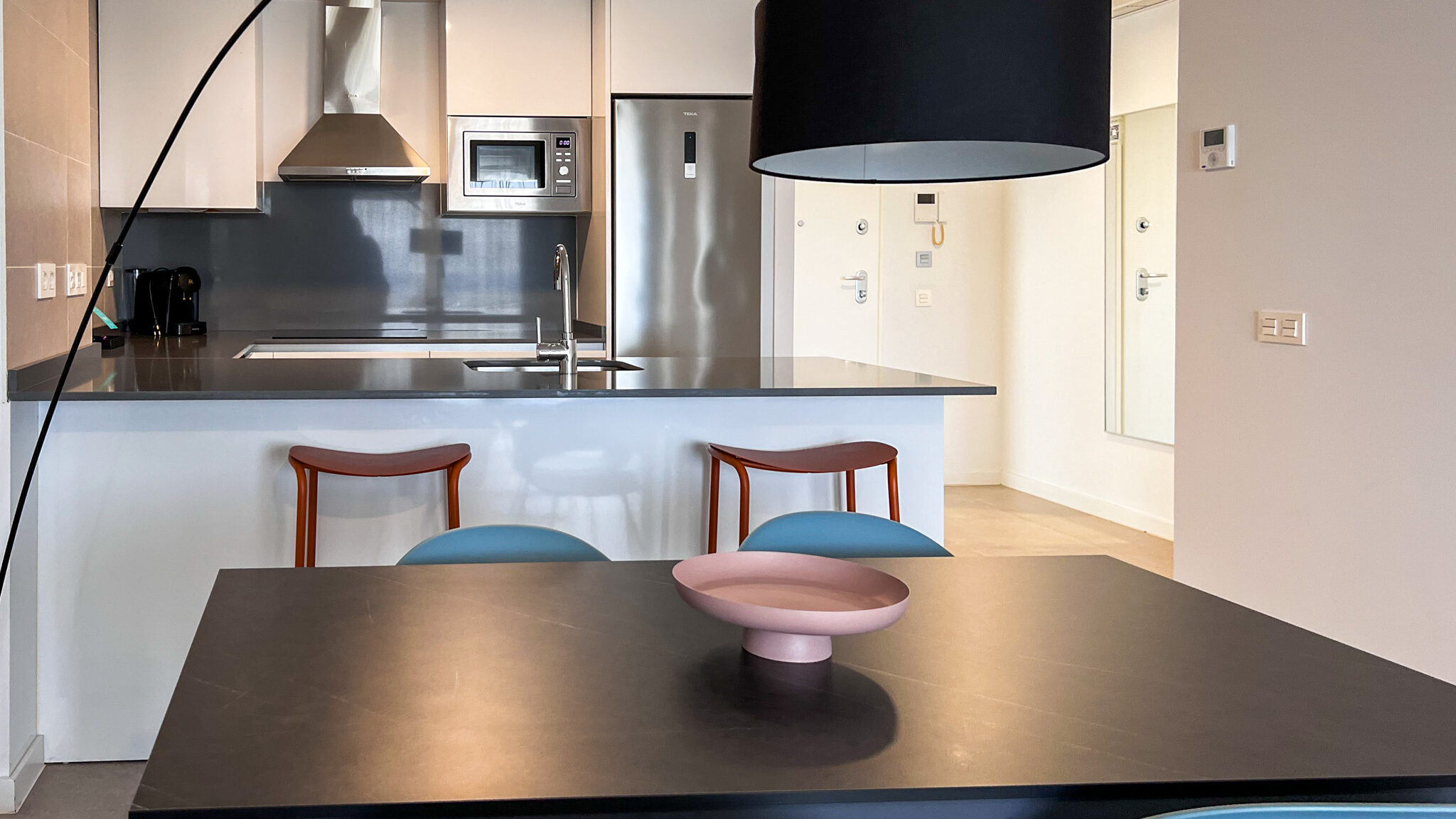 Open plan kitchen with dining table in apartment.