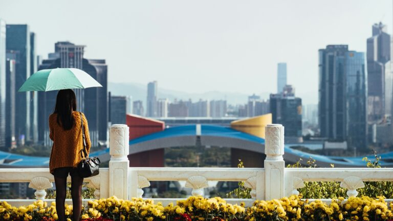 Girl with umbrella looking at Shenzhen.