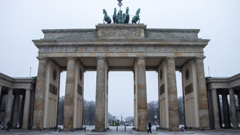 Historic gate on cloudy day free things to do in Berlin.