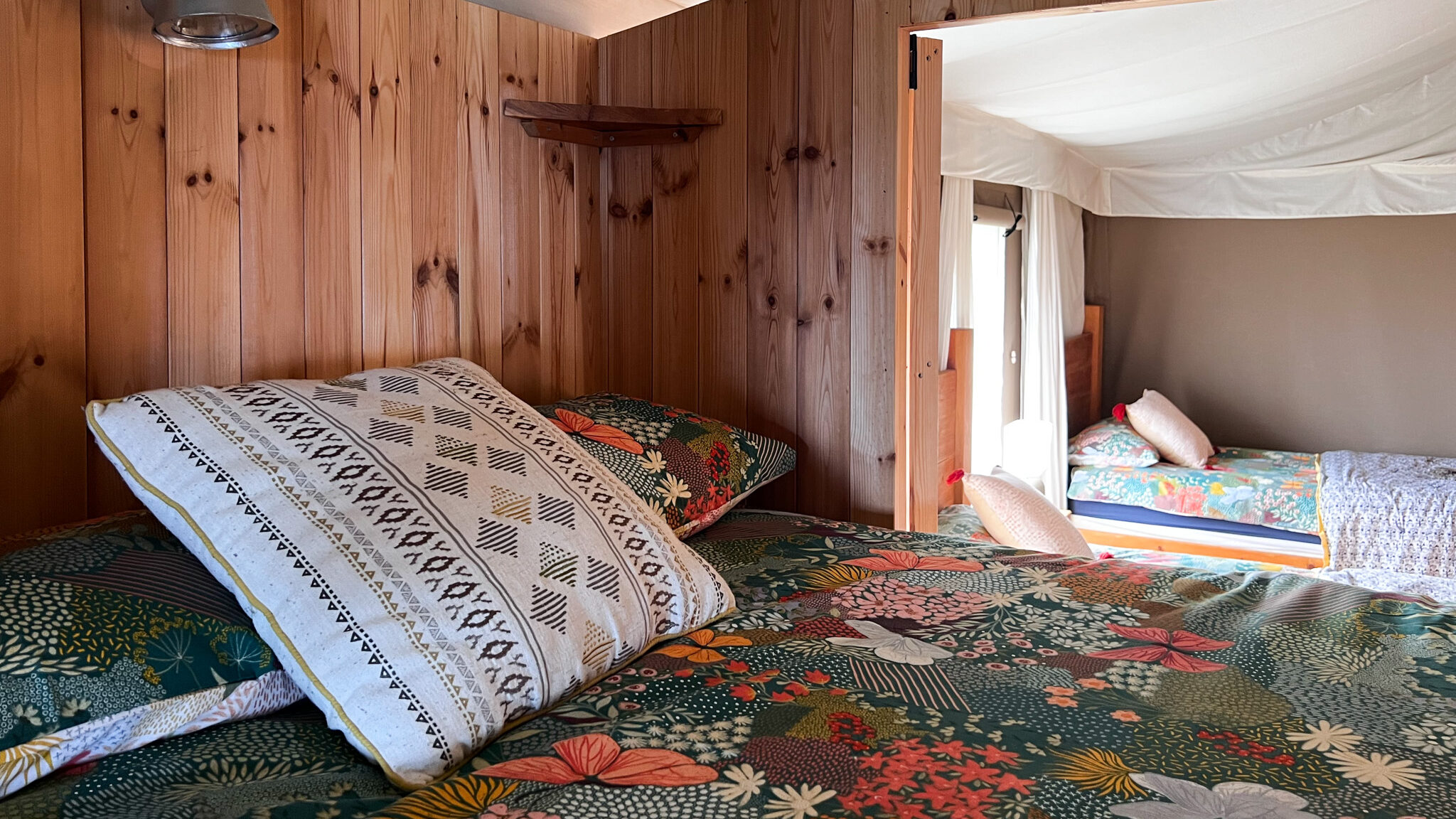 Double bed next to twin bedroom in lodge.