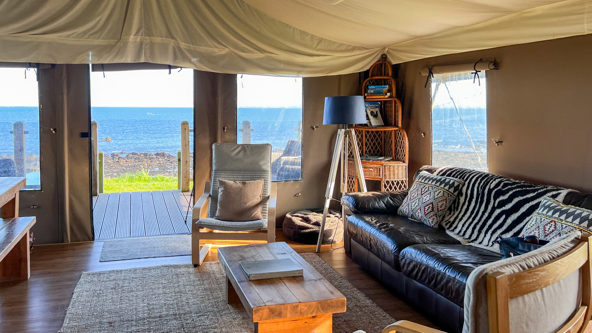 Seating area in safari lodge with sea view.