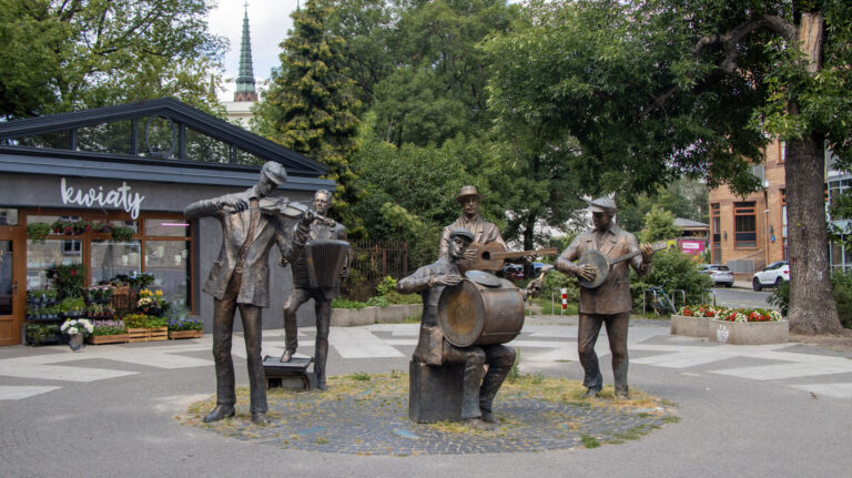 Band statue in small square in Warsaw.