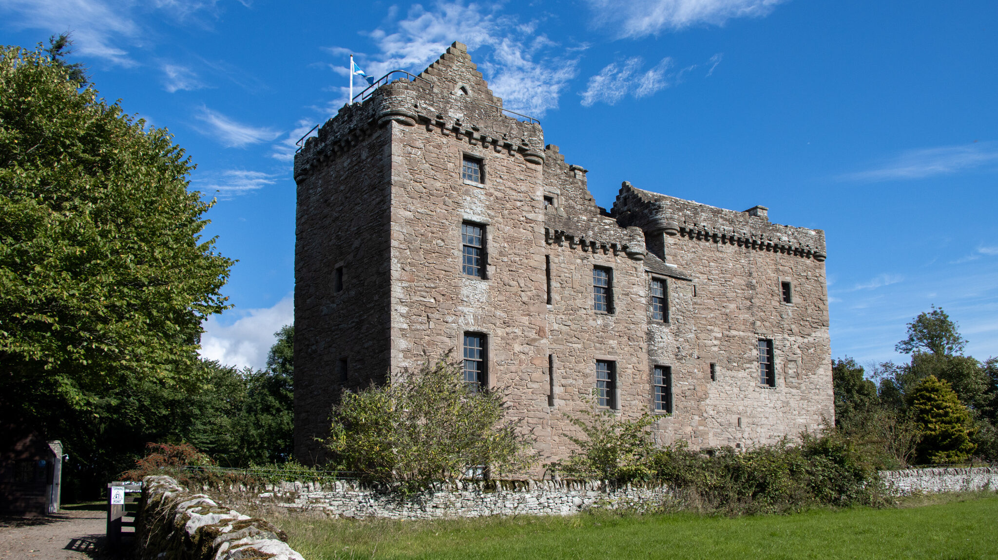 Small medieval castle in field.