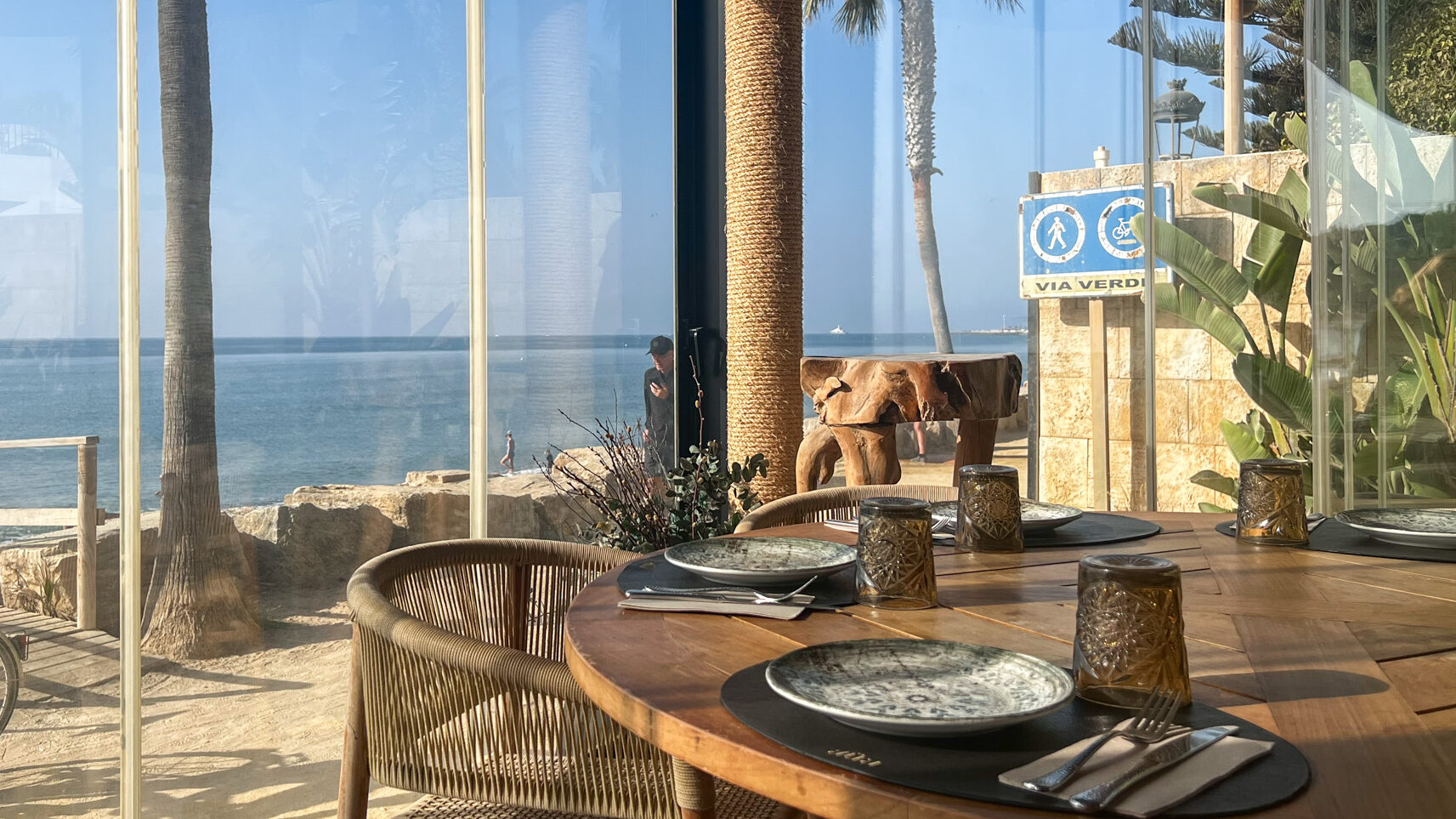 Restaurant with glass walls at beach club in Marbella.