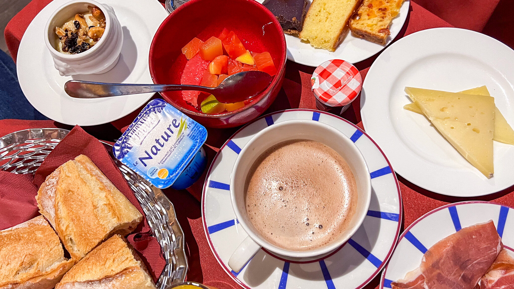 Selection of breakfast items on hotel table.