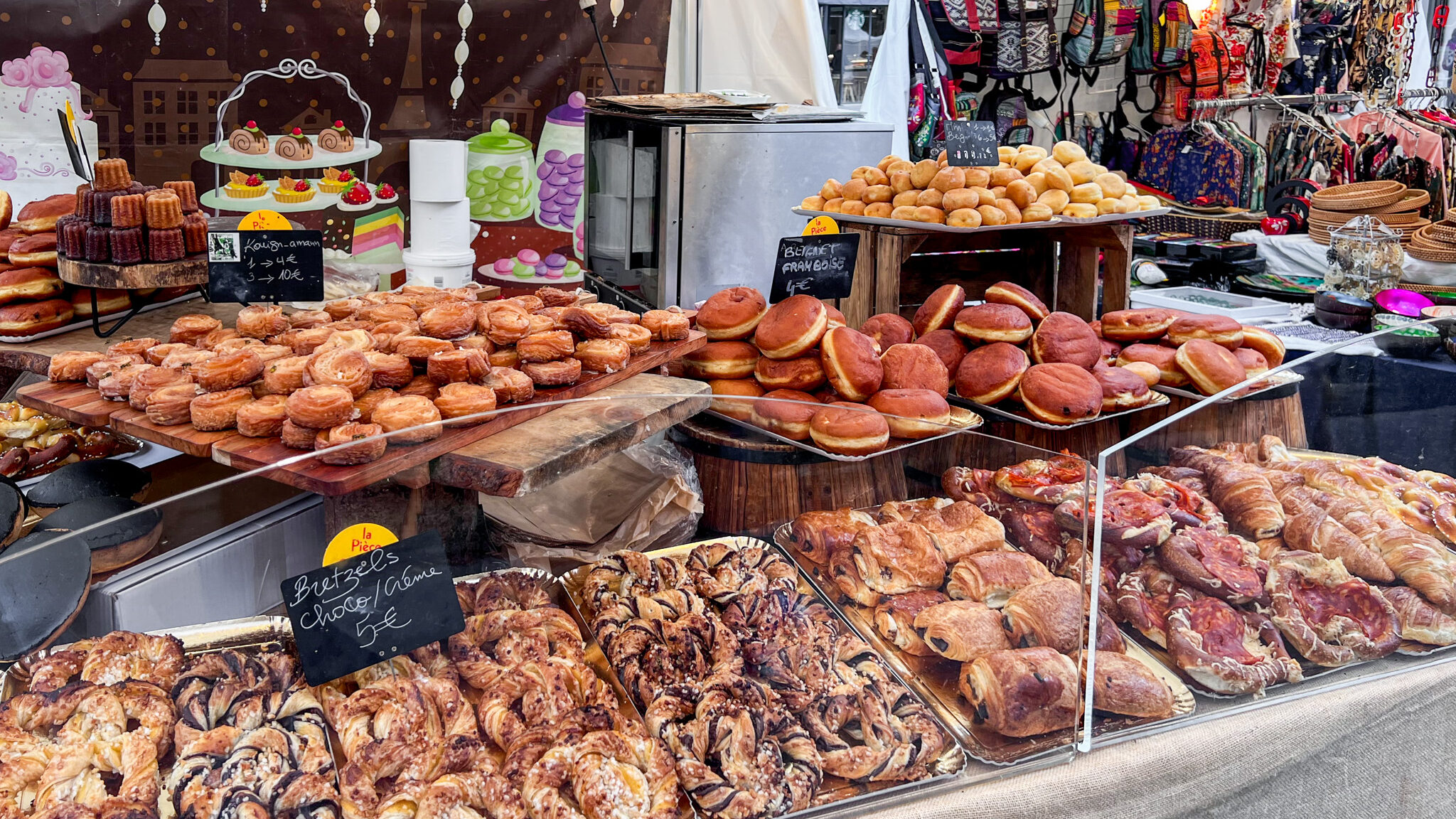 Street market stall filled with baked goods.