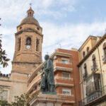 Square in small Spanish town with statue.