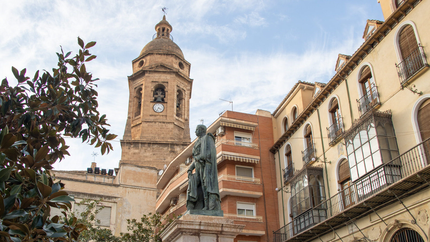 Square in small Spanish town with statue.