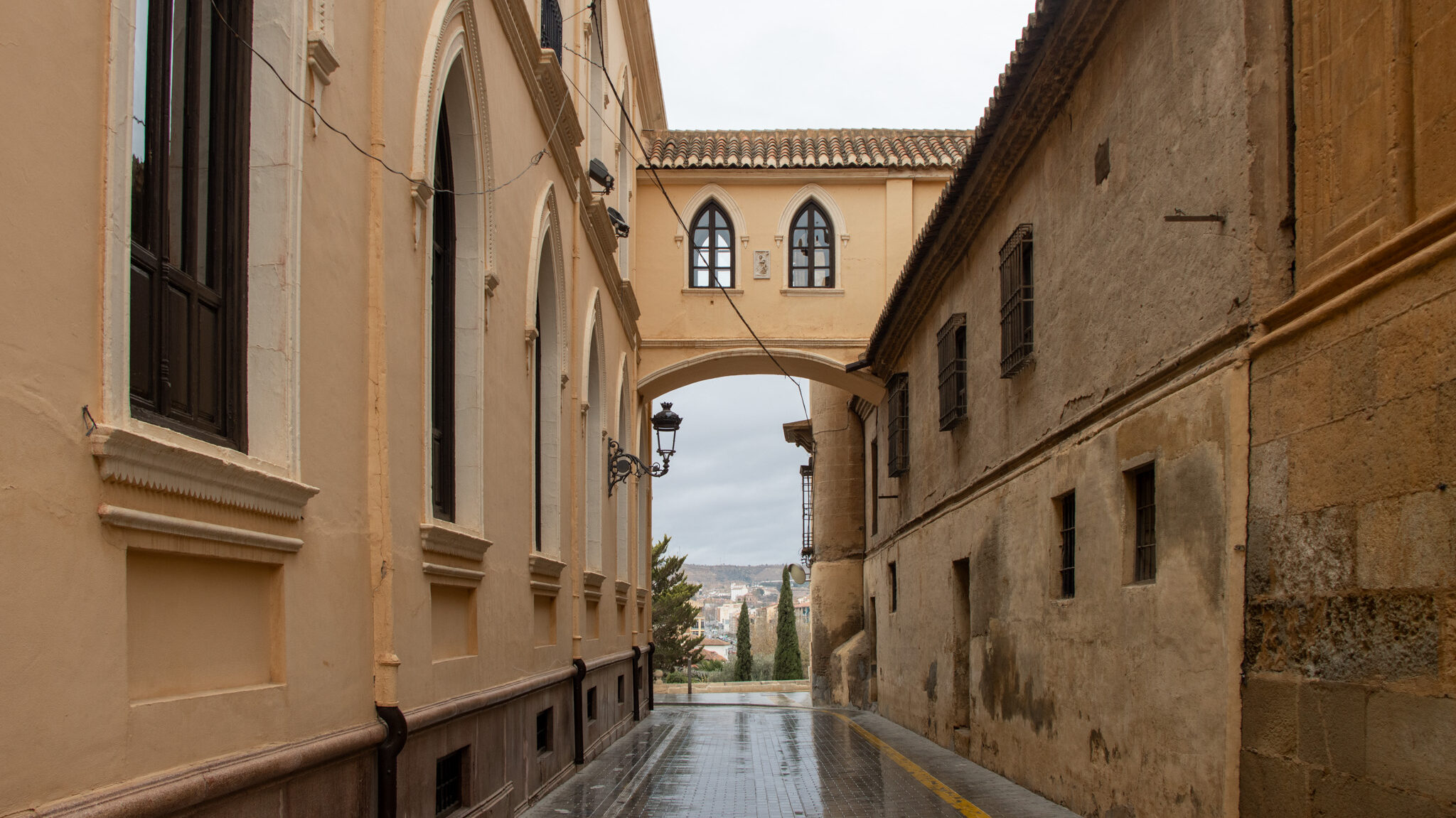 Arch crossing street next to cathedral.