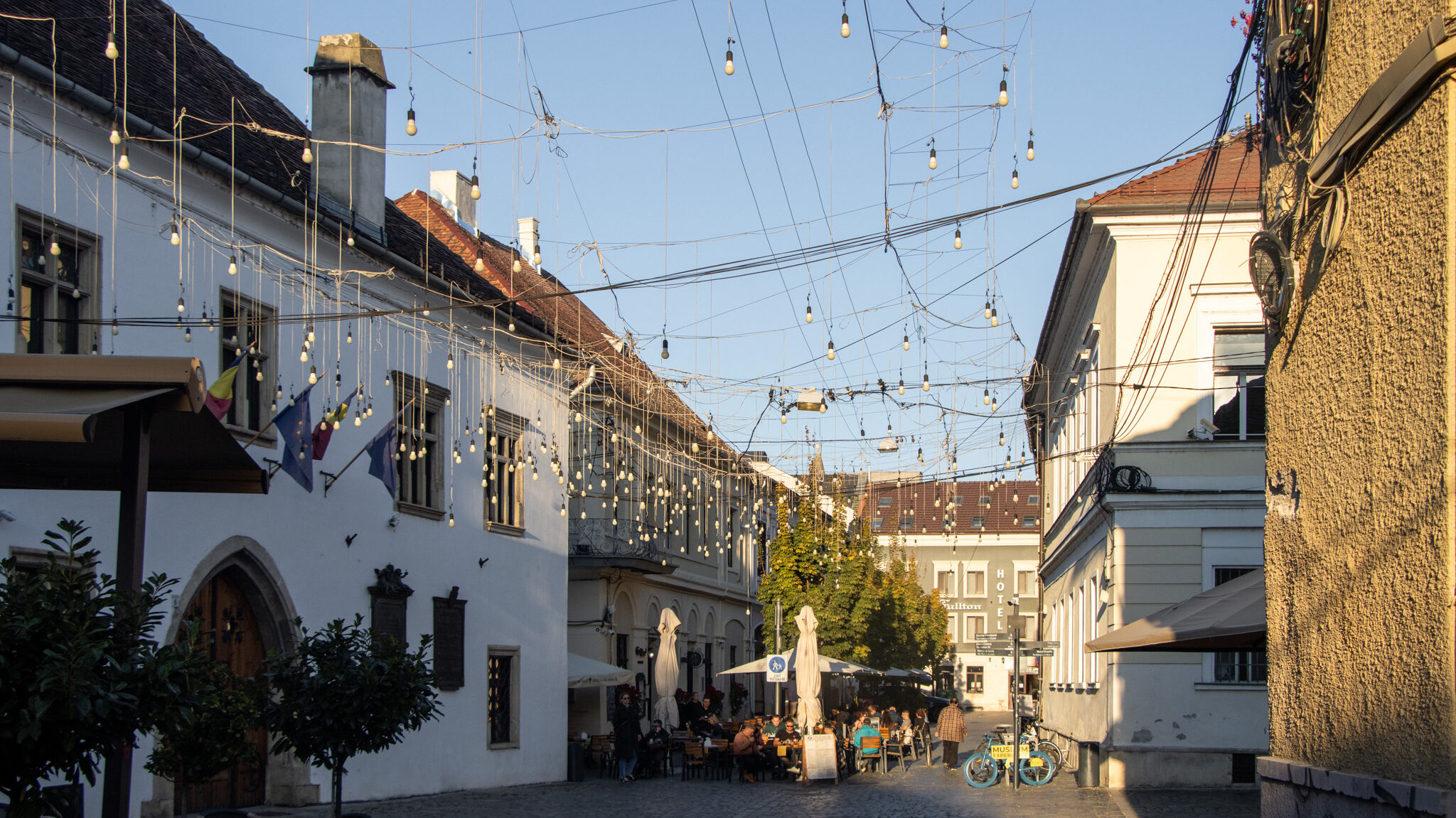 Street in Cluj old town with hanging lights.