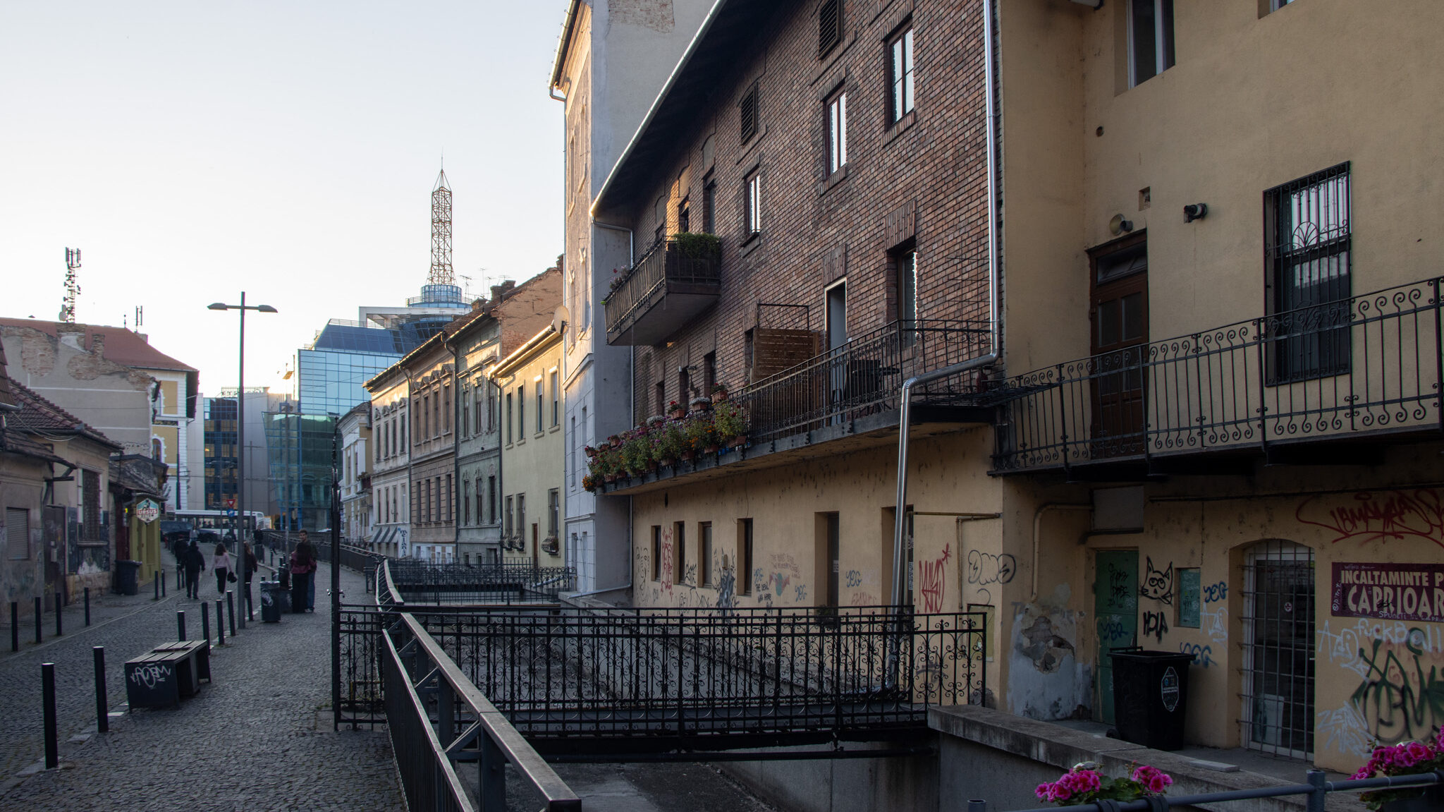 Empty canal lined with shops in Cluj.