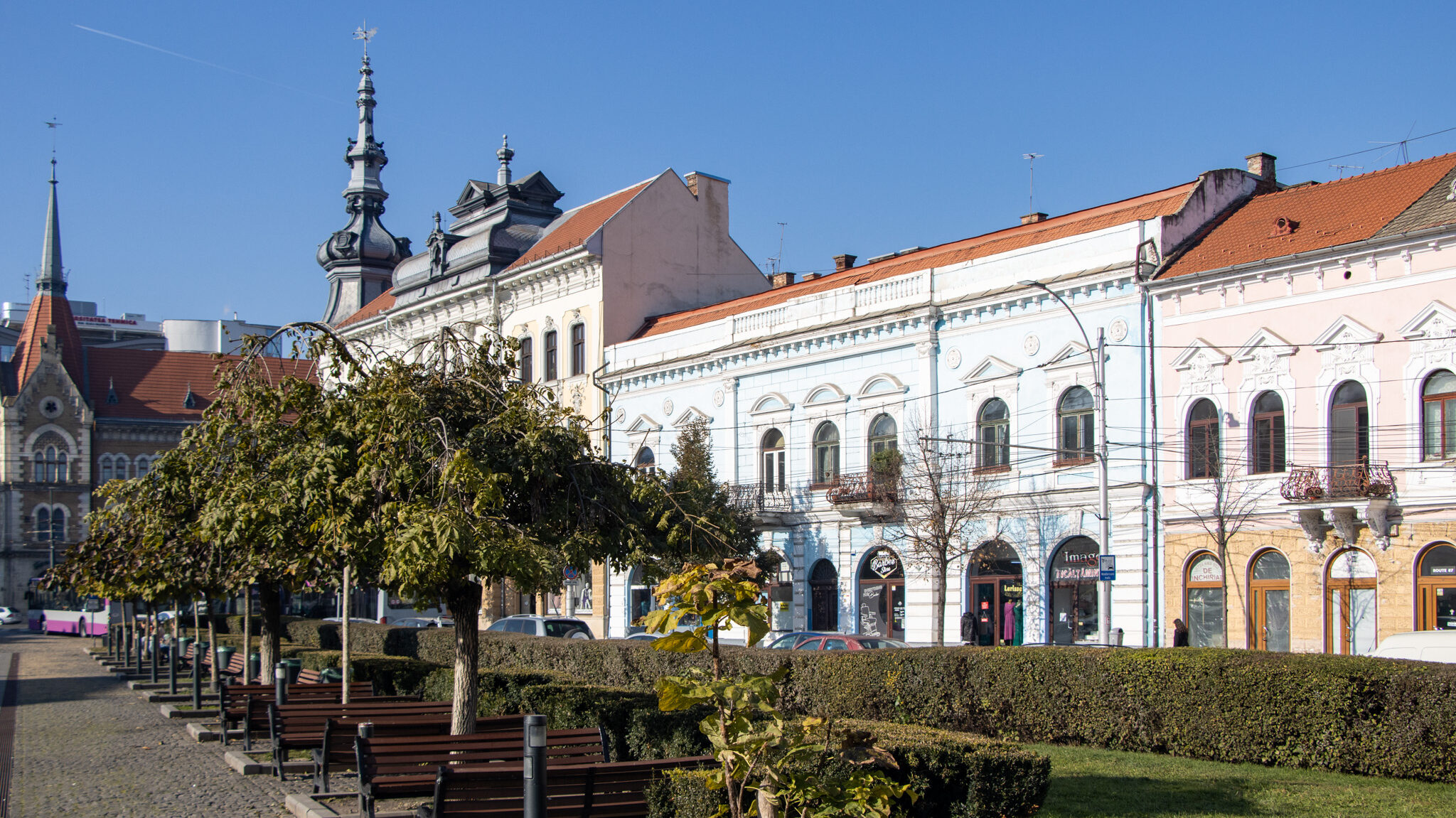 Row of colourful buildings along street in Cluj.