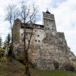 View of Bran Castle from below on hill.