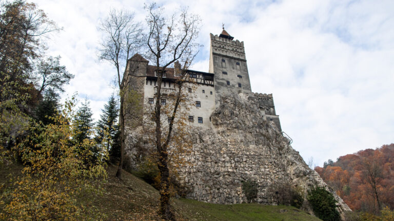 View of Bran Castle from below on hill.