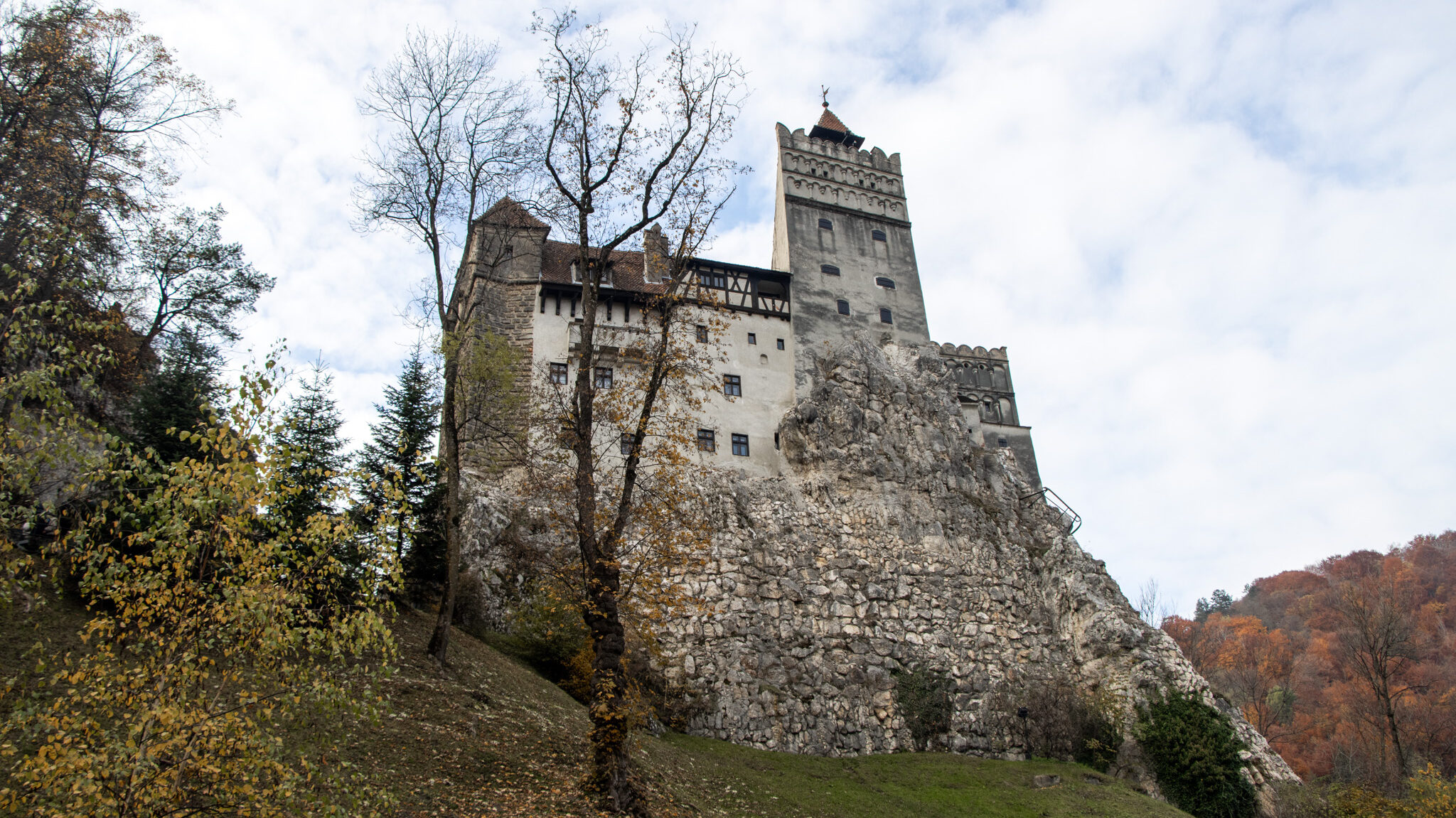 View of Bran Castle from below on hill.
