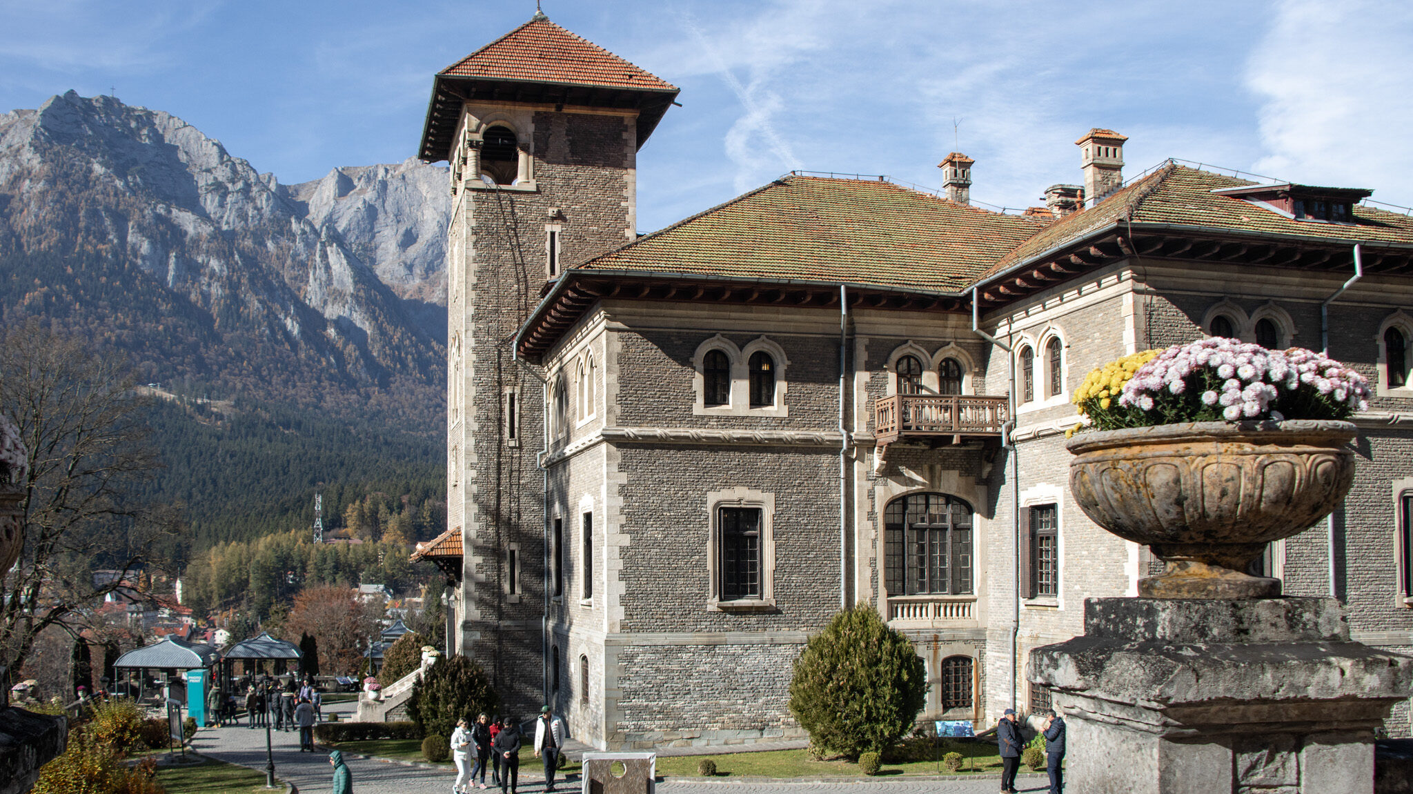 Cantacuzino Castle Romania | Krista the Explorer Cantacuzino Castle with mountain backdrop.