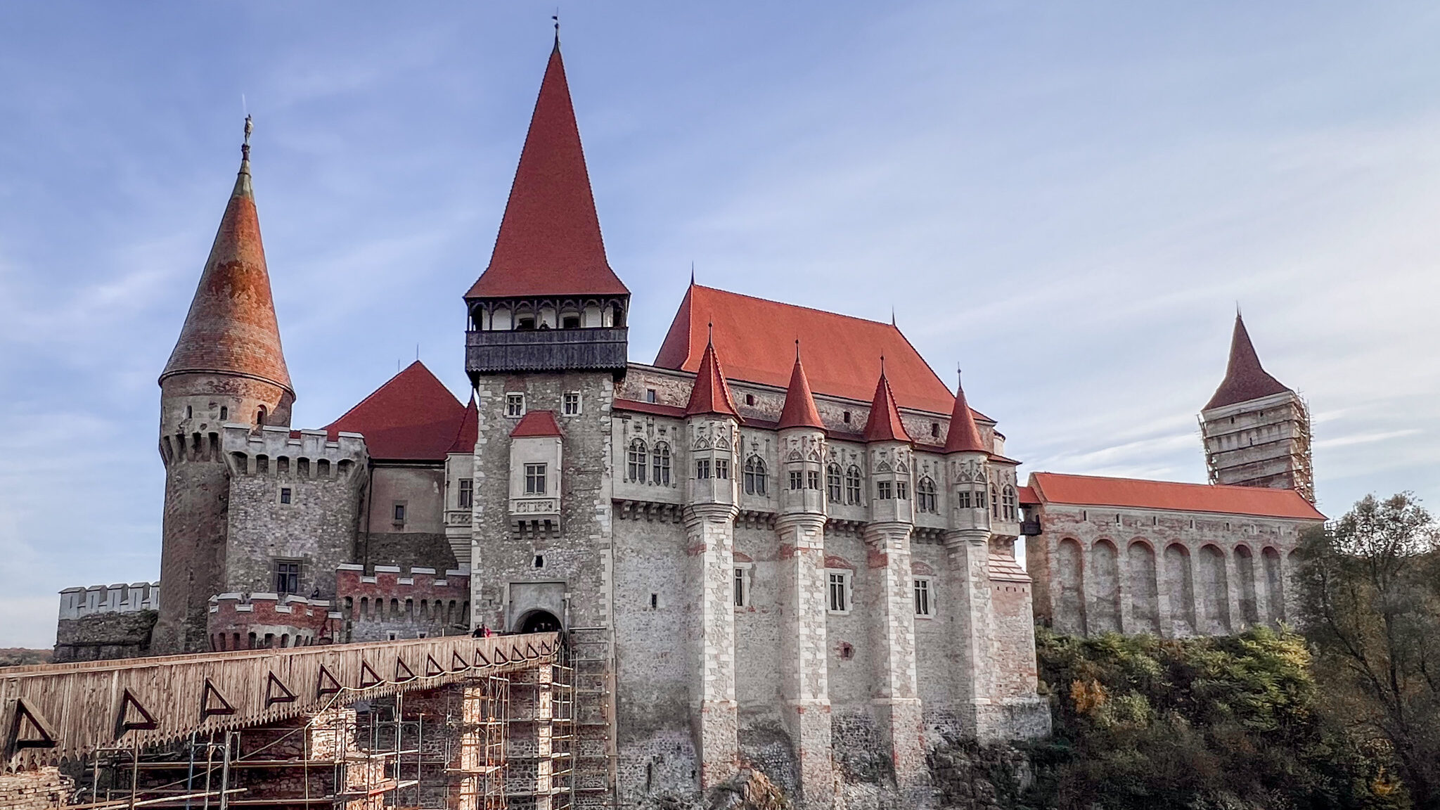 Corvin Castle Romania | Krista the Explorer Gothic castle with wooden bridge across moat.