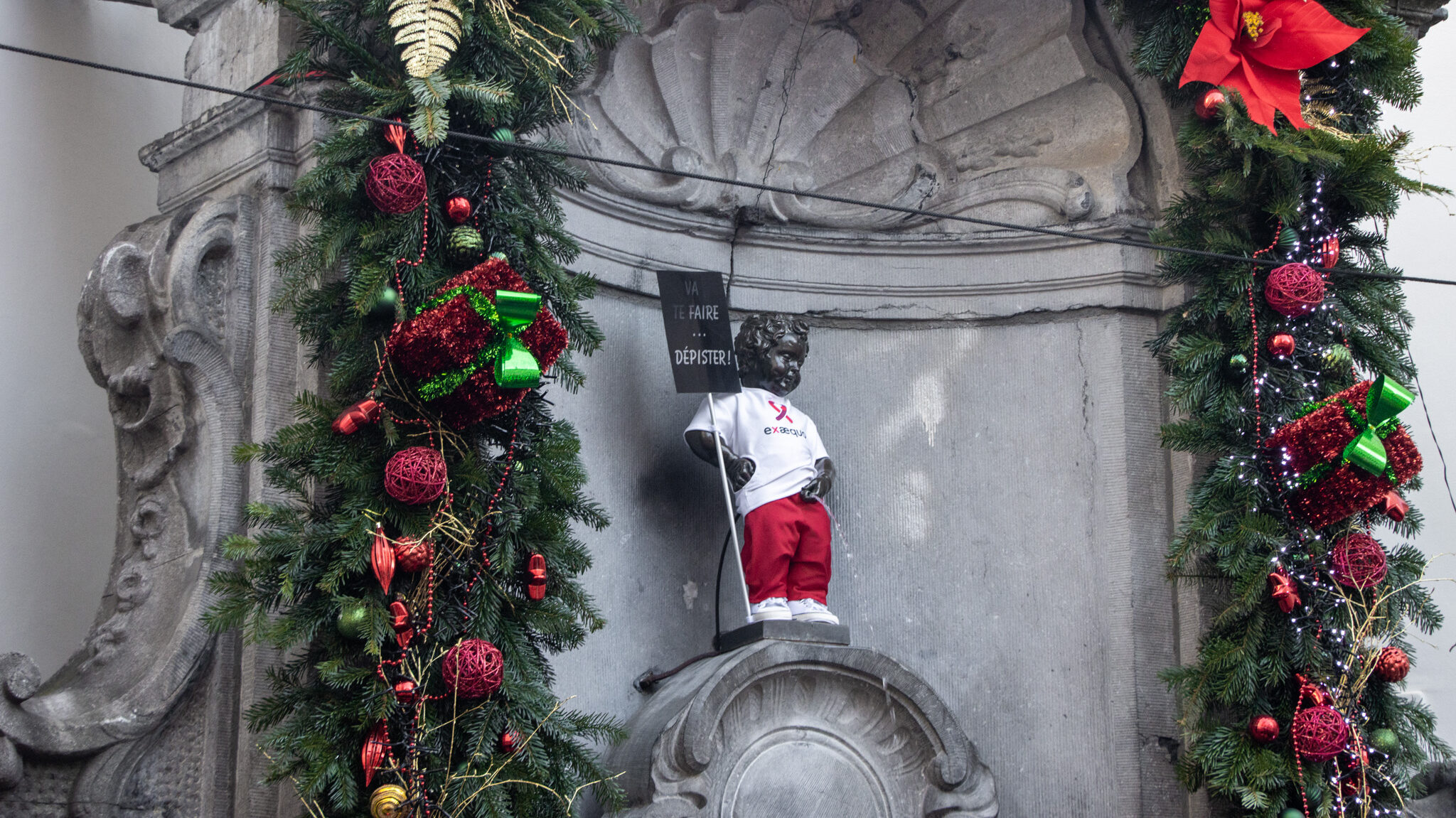 Small statue of boy weeing into fountain.