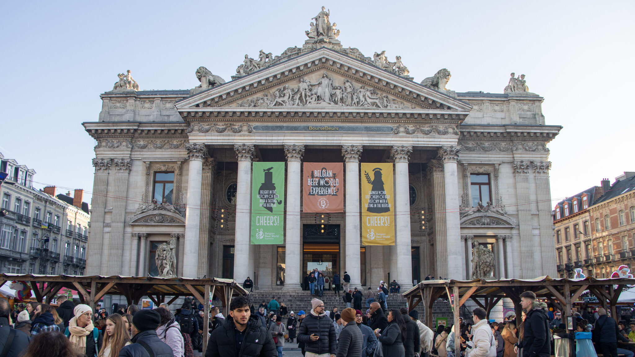 Large building with Christmas market in front.