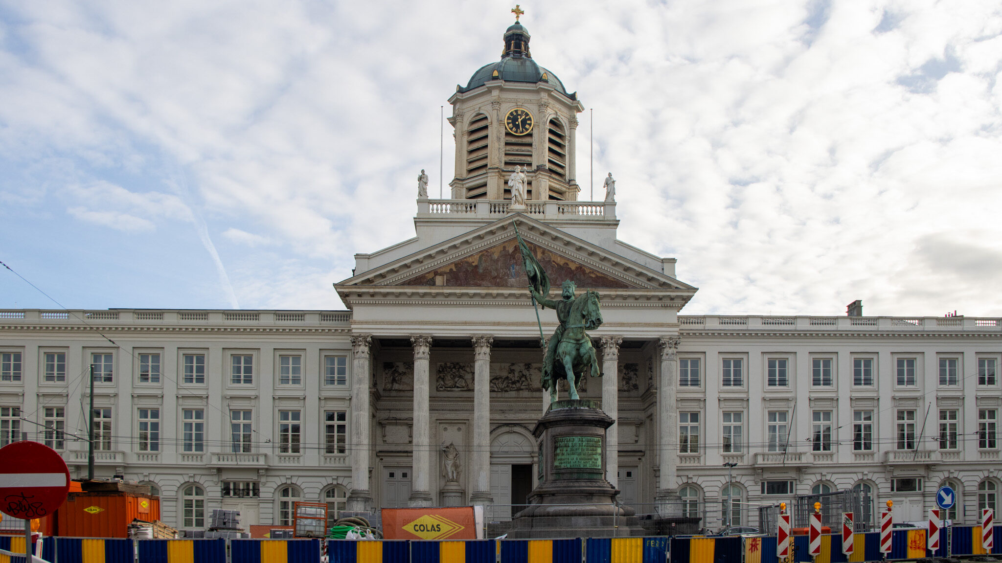 Historic palace in Brussels with statue in front.