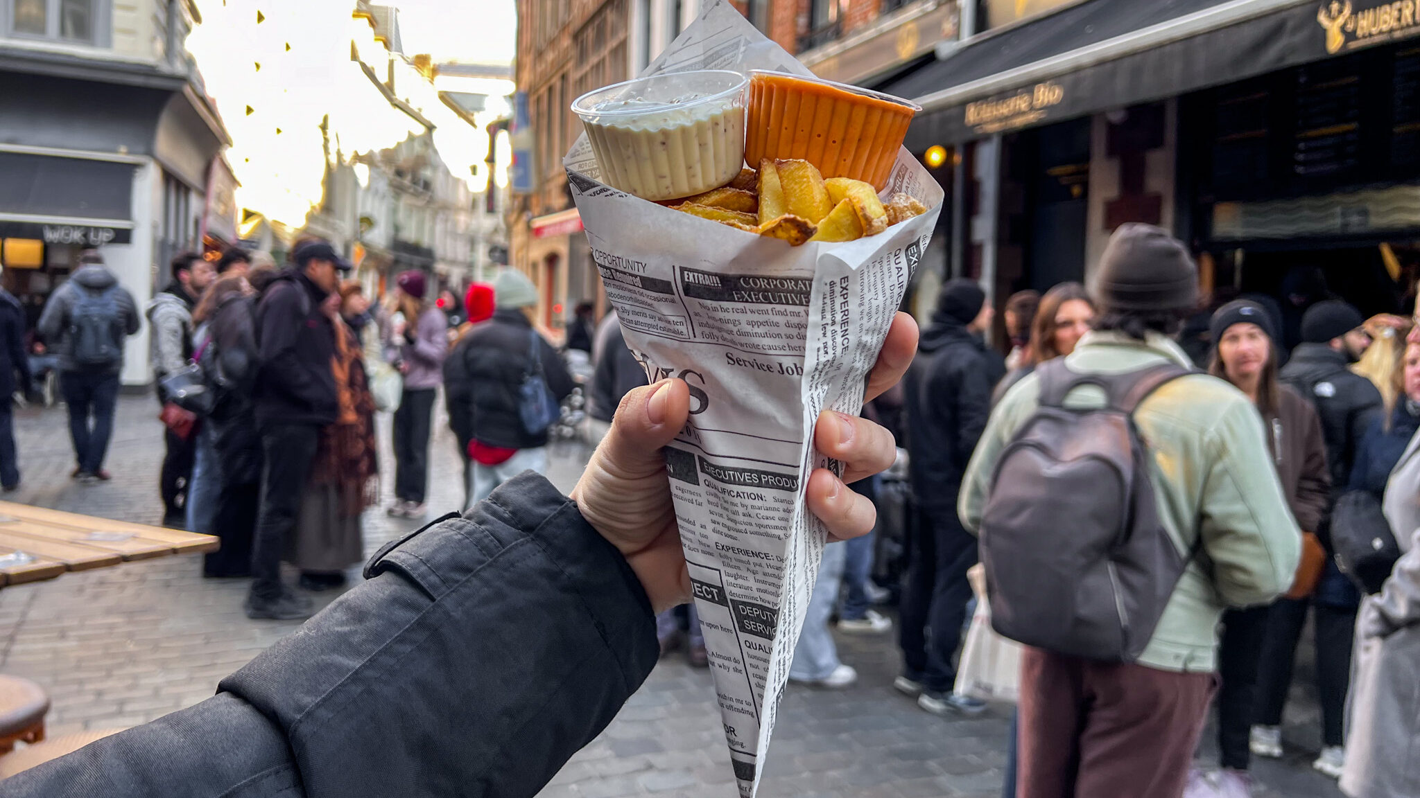 Belgian fries in paper cone with sauces. 