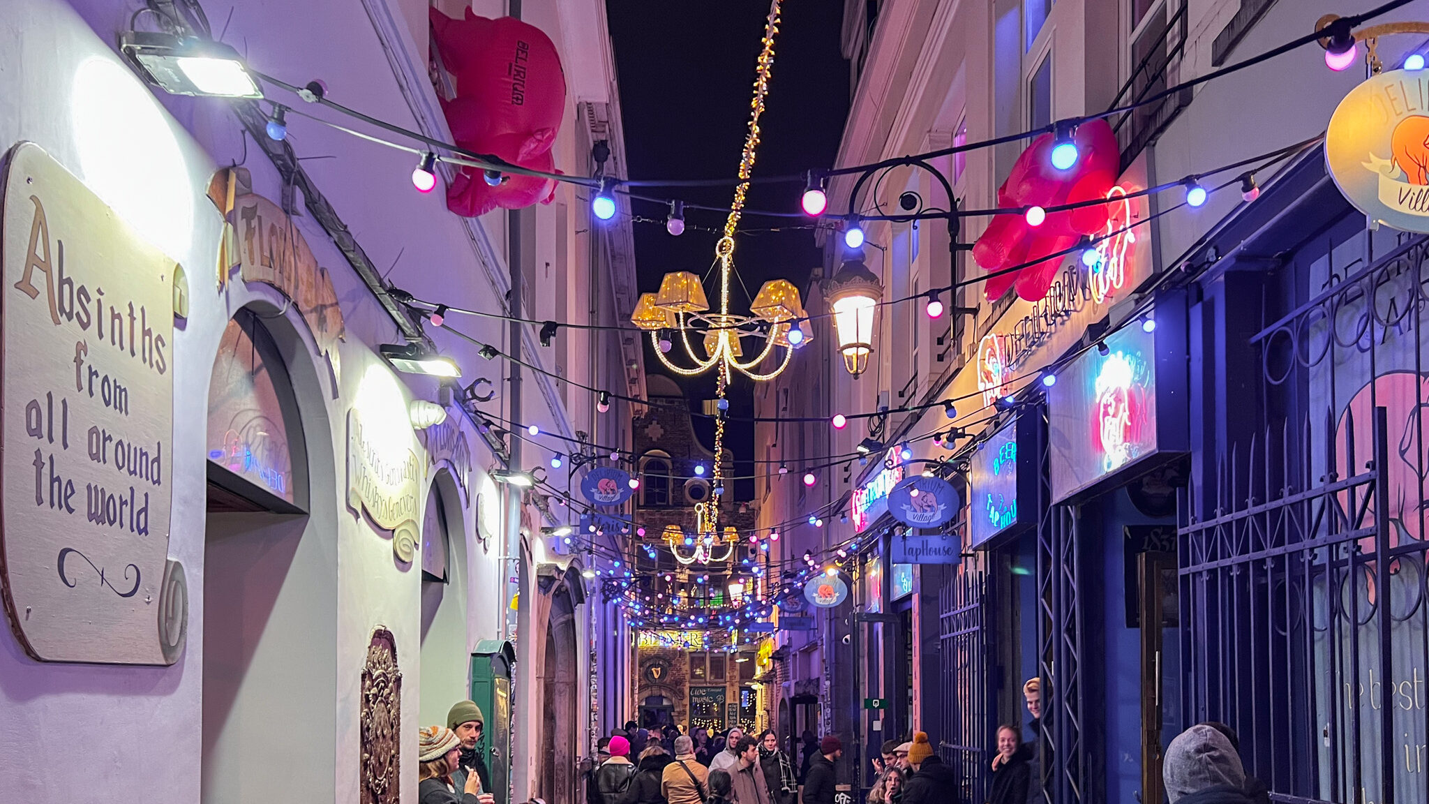 Street lined with bars and bright lights. 