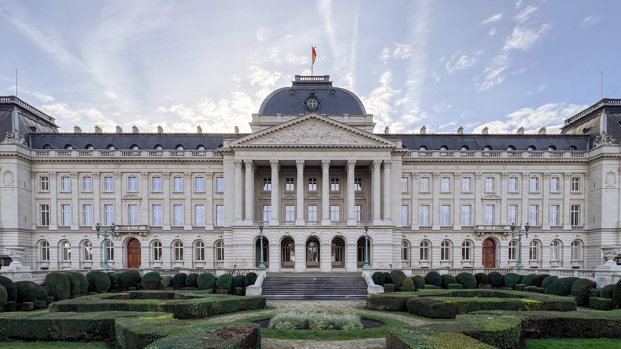 Large palace building with front garden.