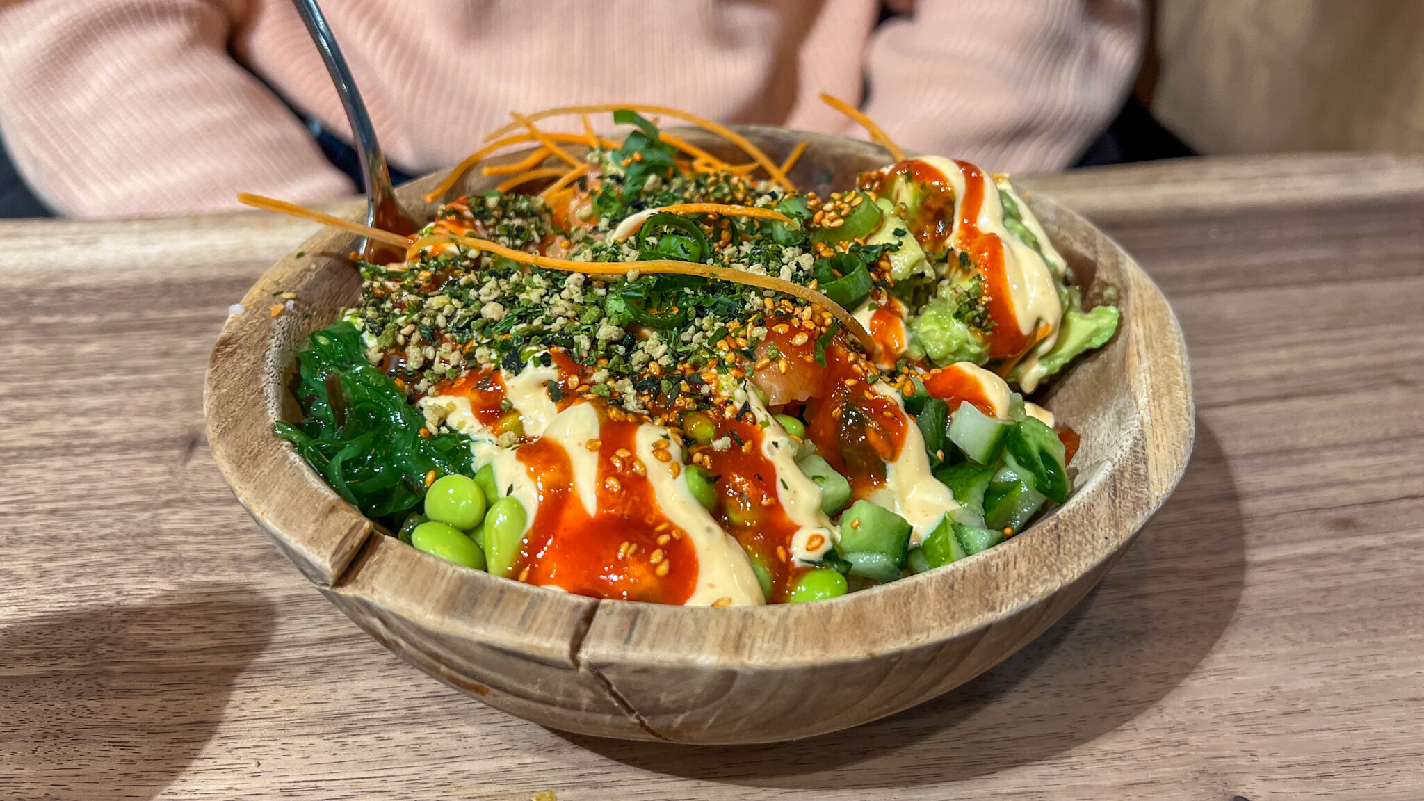 Fresh poke bowl in bamboo bowl.