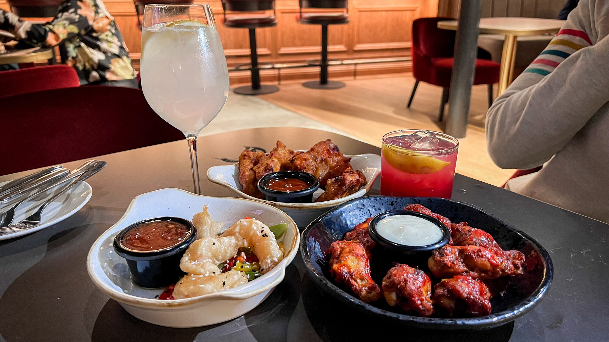 Cocktails and snack food dishes at hotel restaurant.