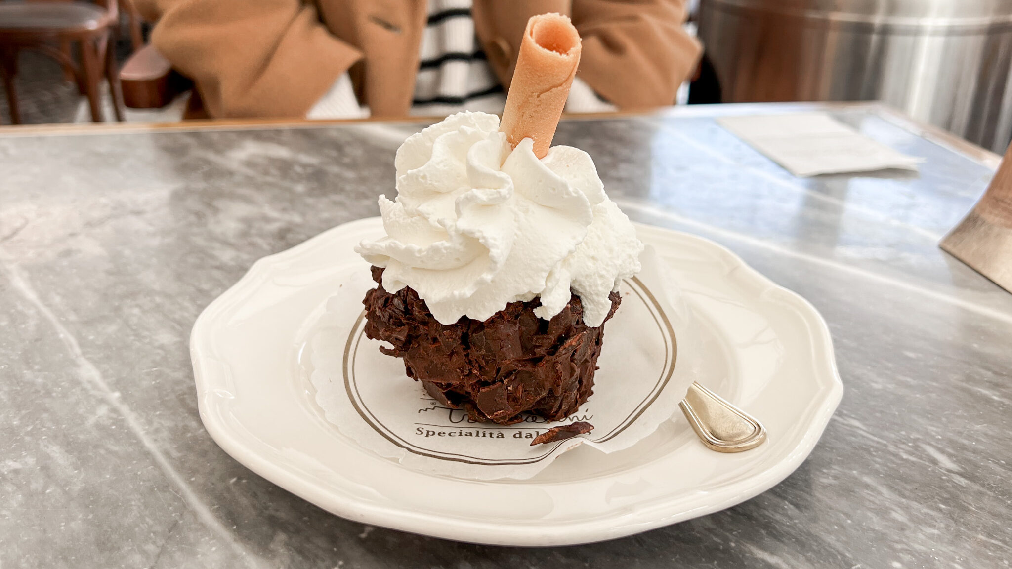 Chocolate dessert topped with cream.