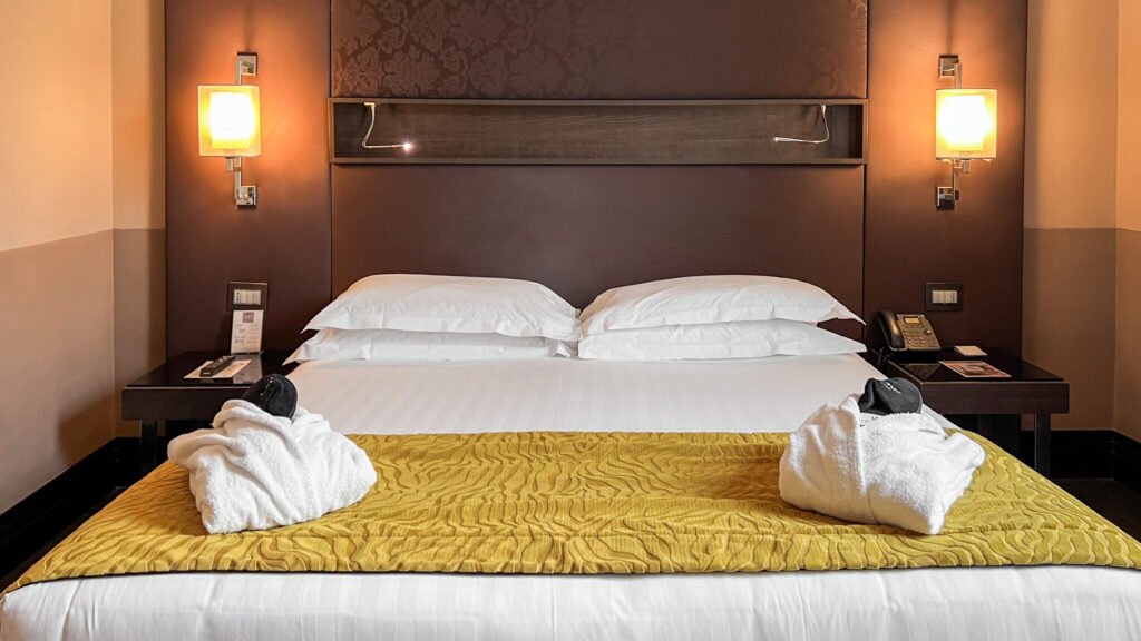 Rome Times Hotel | Krista the Explorer Double bed inside modern hotel room in Rome.